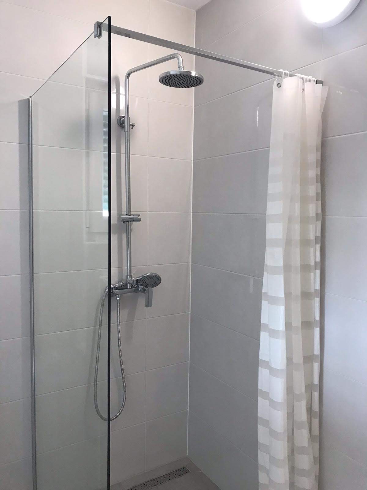 Walk-in shower with rainfall showerhead
